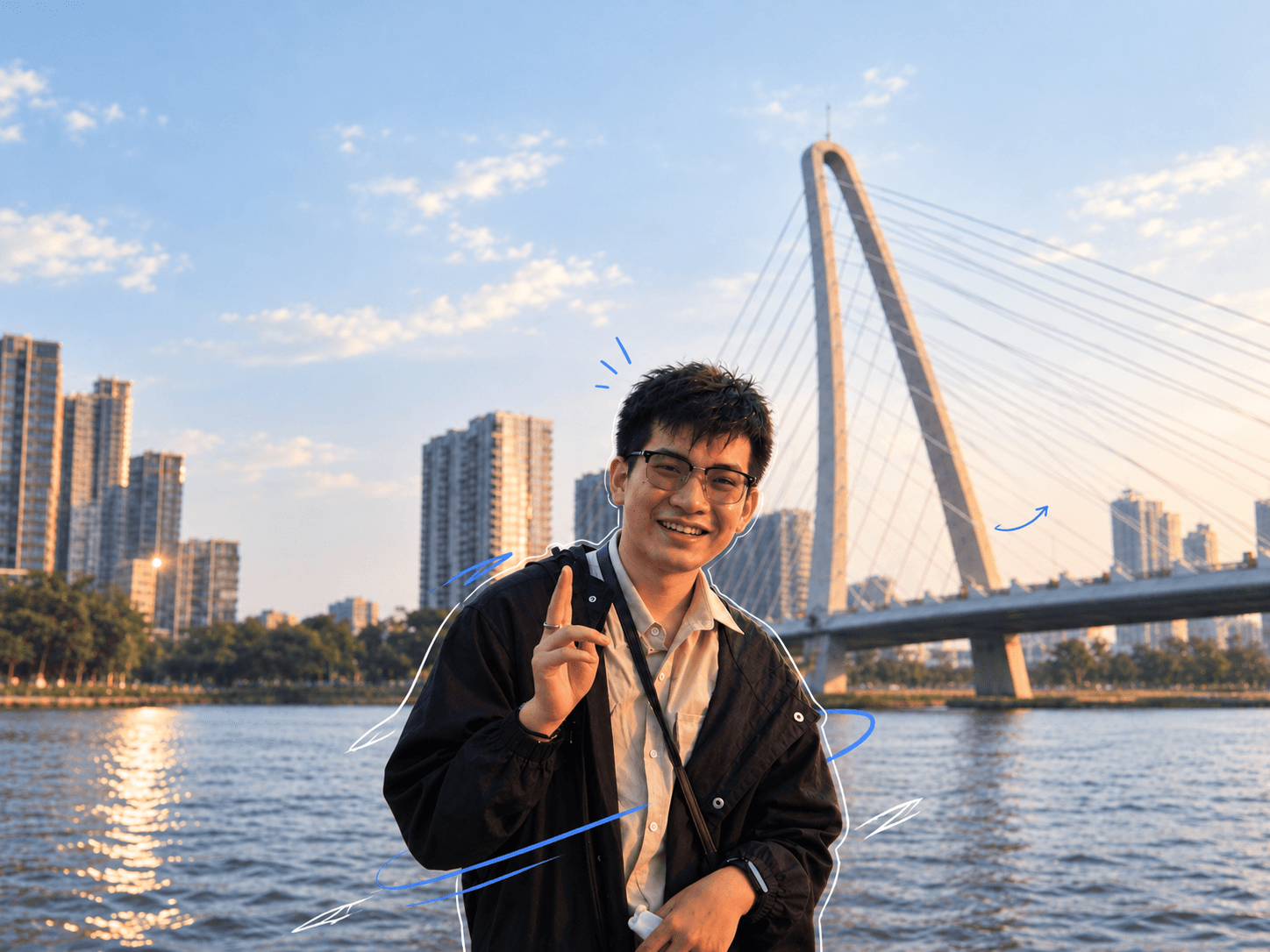 Phan Duc Sung standing beside a river and cable-stayed bridge